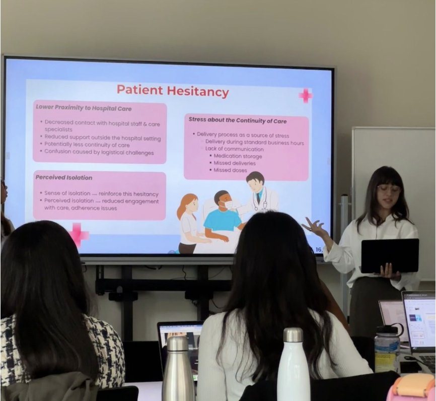 Shiloh presenting a slide on patient hesitancy to classmates at emlyon